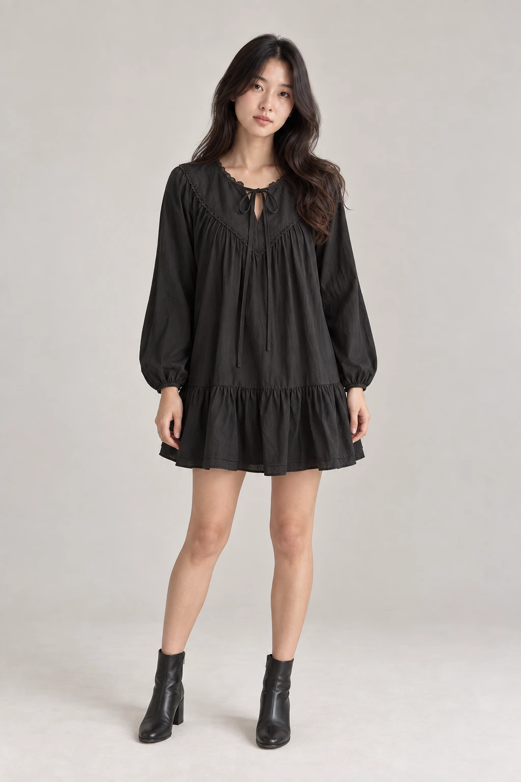 Korean model wearing the black lace-trimmed smock mini dress with a ruffled hem and black ankle boots